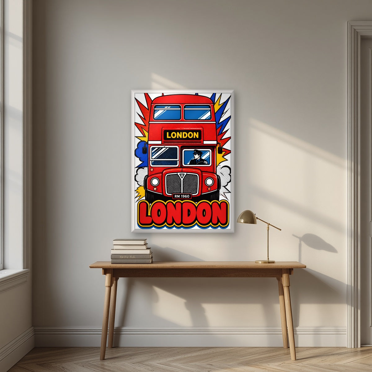 Routemaster London art print in a white frame, above an oak writing desk