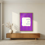 Love You More – Capri Violet print in an oak frame in a living room