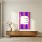Love You More – Capri Violet print in a white frame in a living room