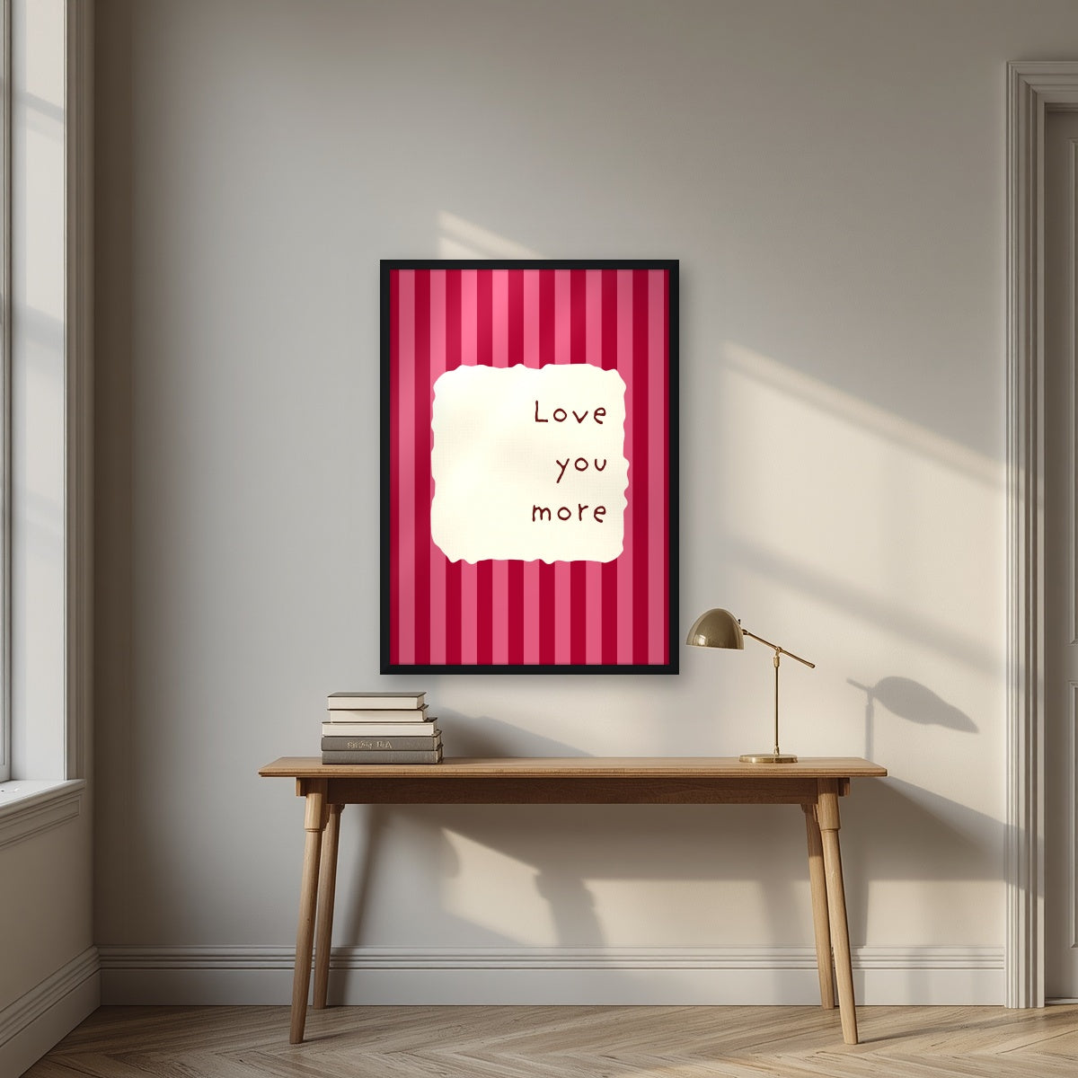 Love You More – Claret Stripe print in a black frame above a desk