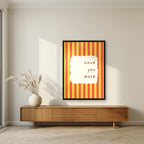 Love You More – Marmalade Stripe print in a black frame in a living room