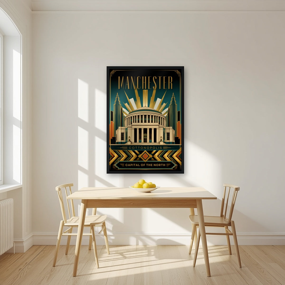 Cottonopolis Manchester art print in a black frame, above a dining table in a bright kitchen