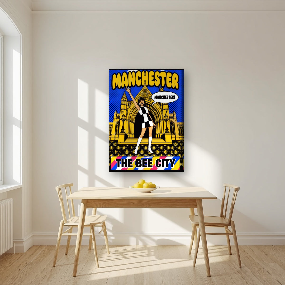 The Bee City Manchester art print on a slim-edge canvas, above a dining table in a bright kitchen