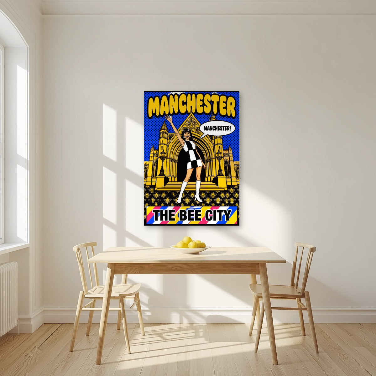 The Bee City Manchester art print as an unframed print, above a dining table in a bright kitchen
