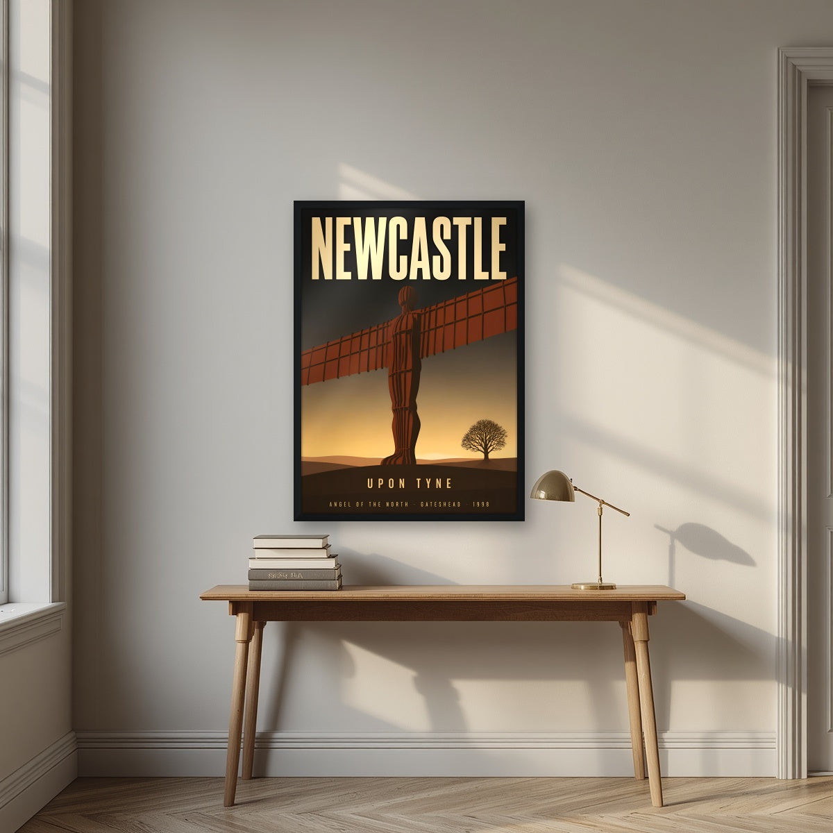 Angel of the North Newcastle art print in a black frame, above an oak writing desk
