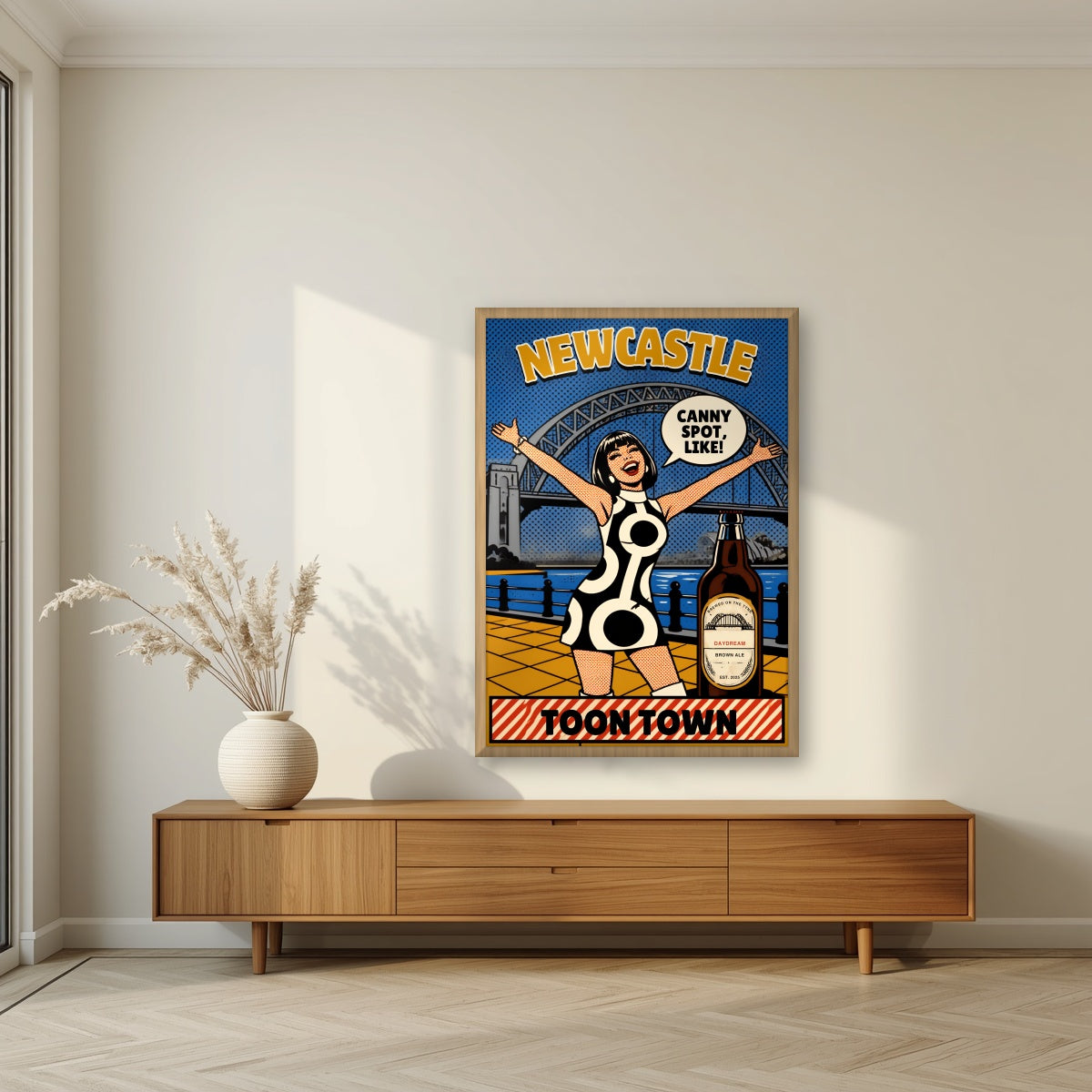 Toon Town Newcastle art print in an oak frame, above a walnut sideboard in a living room