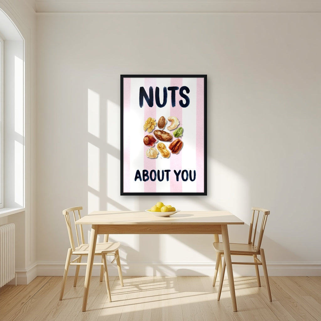 Nuts About You – Positano Pink in a black frame, above a dining table in a bright kitchen