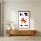 Nuts About You – Positano Pink in a black frame, above a walnut sideboard in a living room