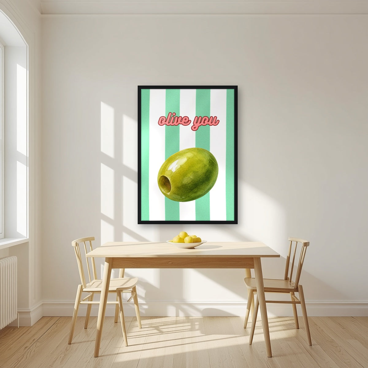 Olive You – Cabana Green in a black frame, above a dining table in a bright kitchen