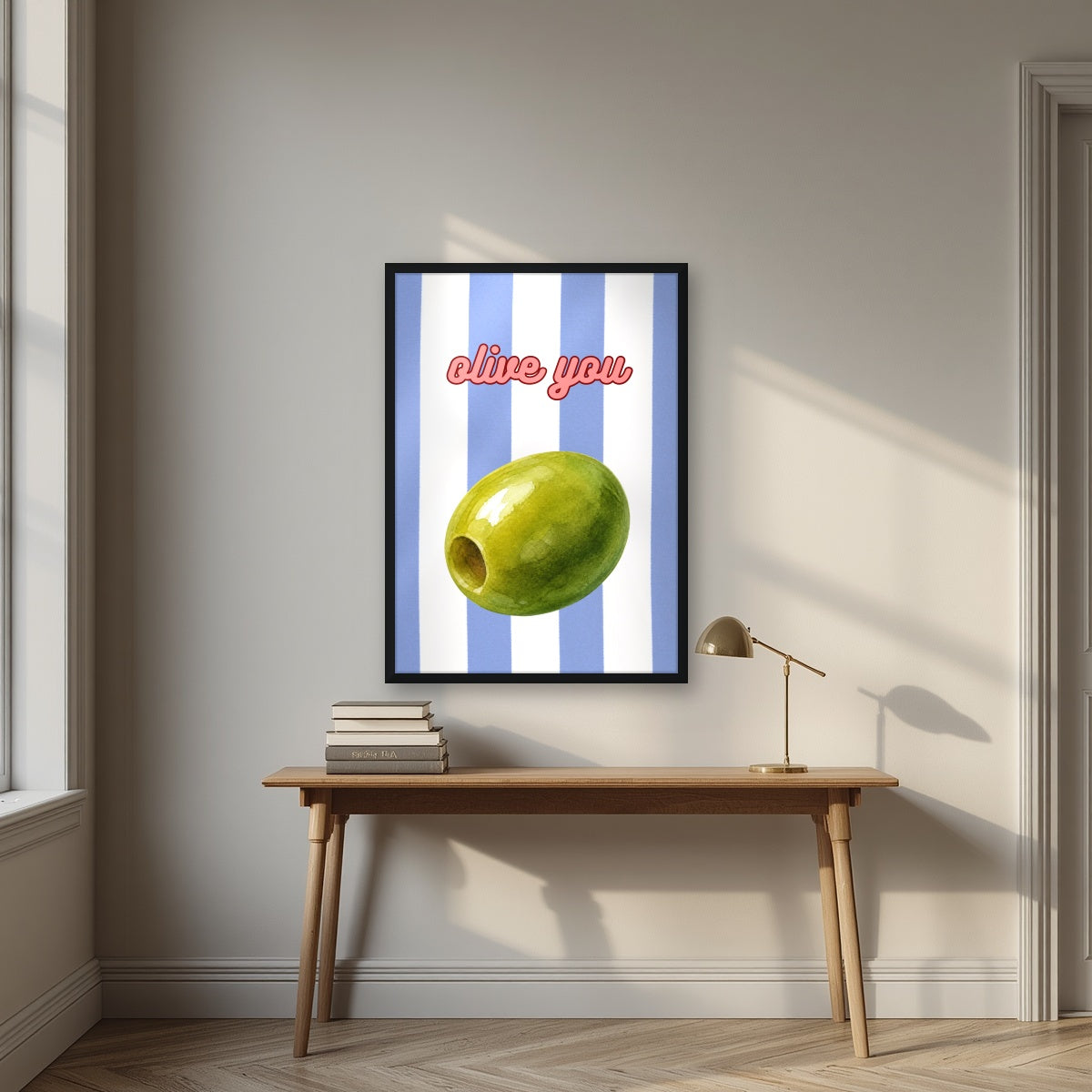Olive You – Capri Violet in a black frame, above an oak writing desk