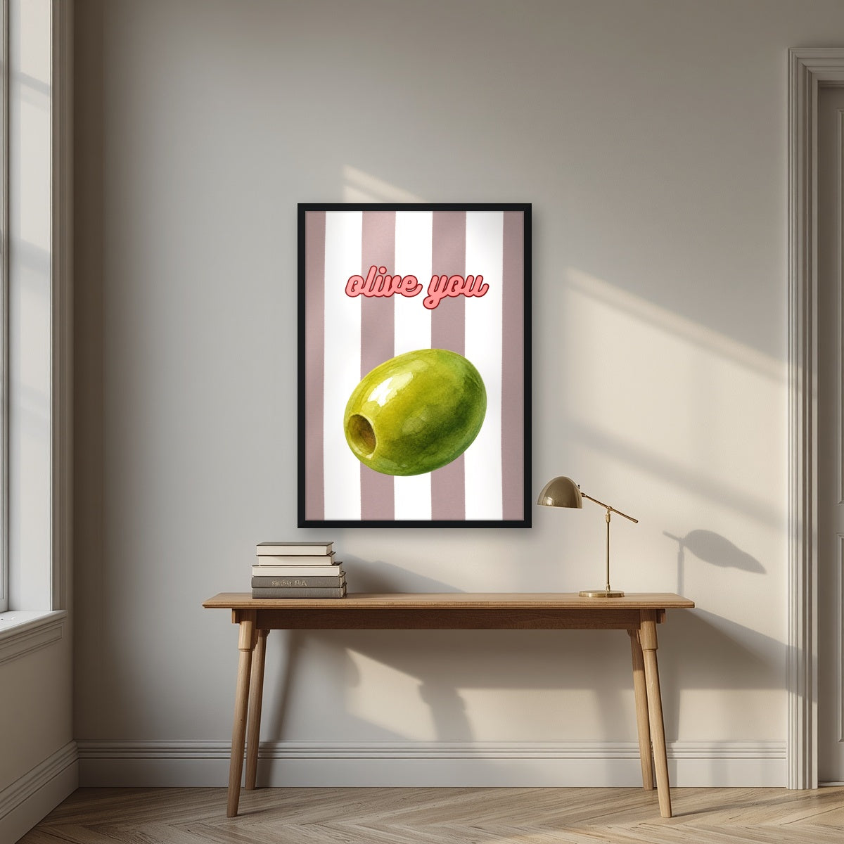 Olive You – Tuscan Taupe in a black frame, above an oak writing desk