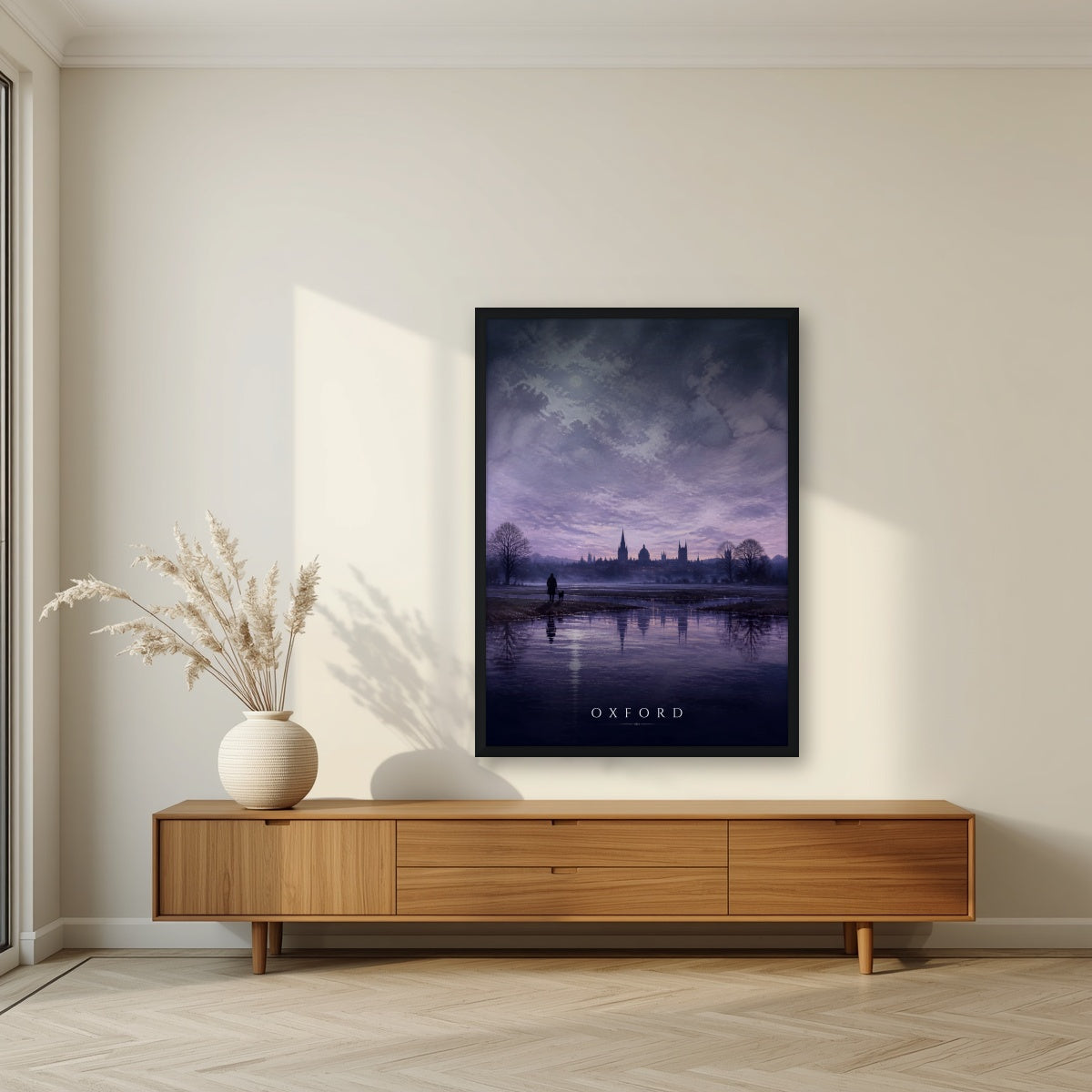 Oxford at Dusk in a black frame, above a walnut sideboard in a living room
