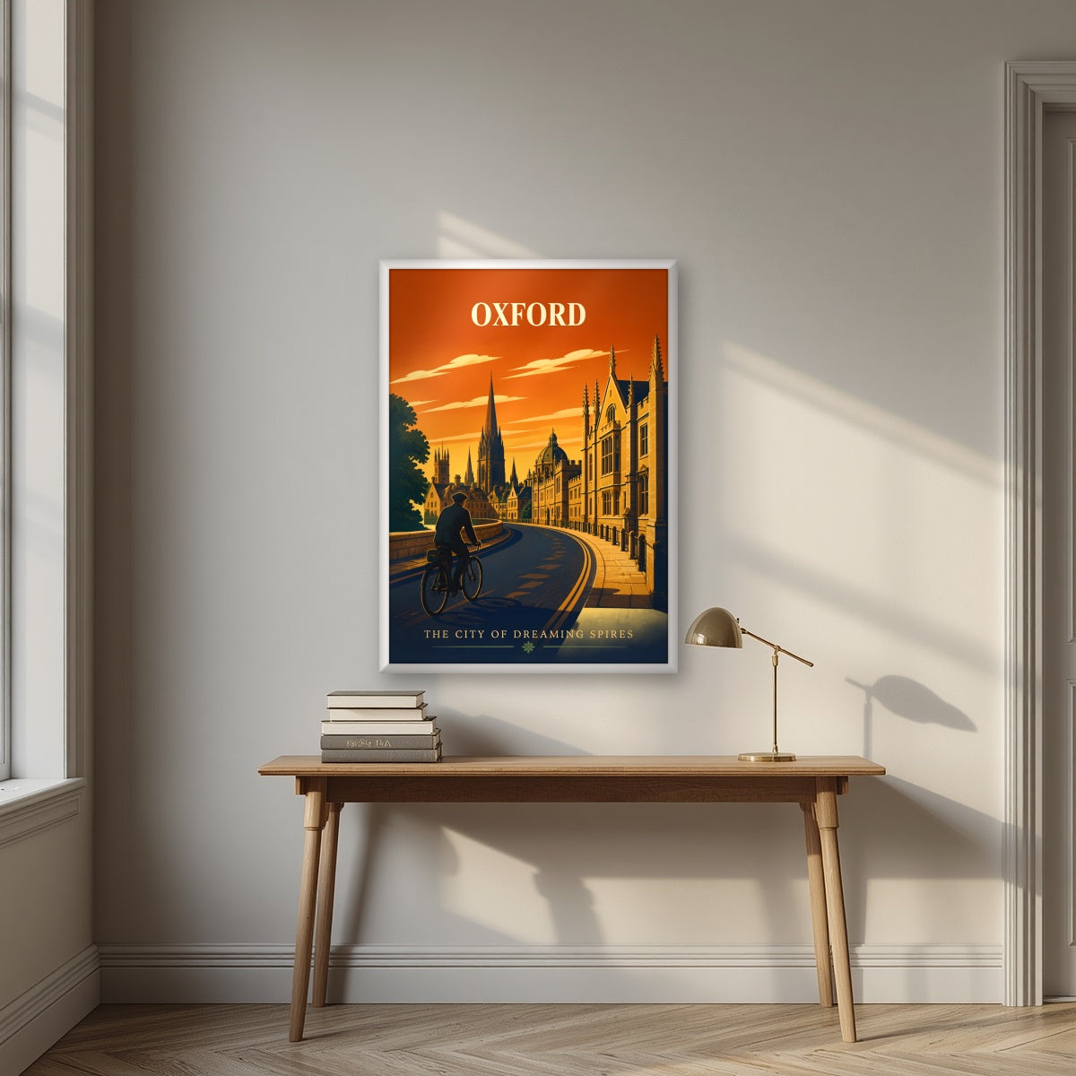 Oxford Dreaming Spires in a white frame, above an oak writing desk