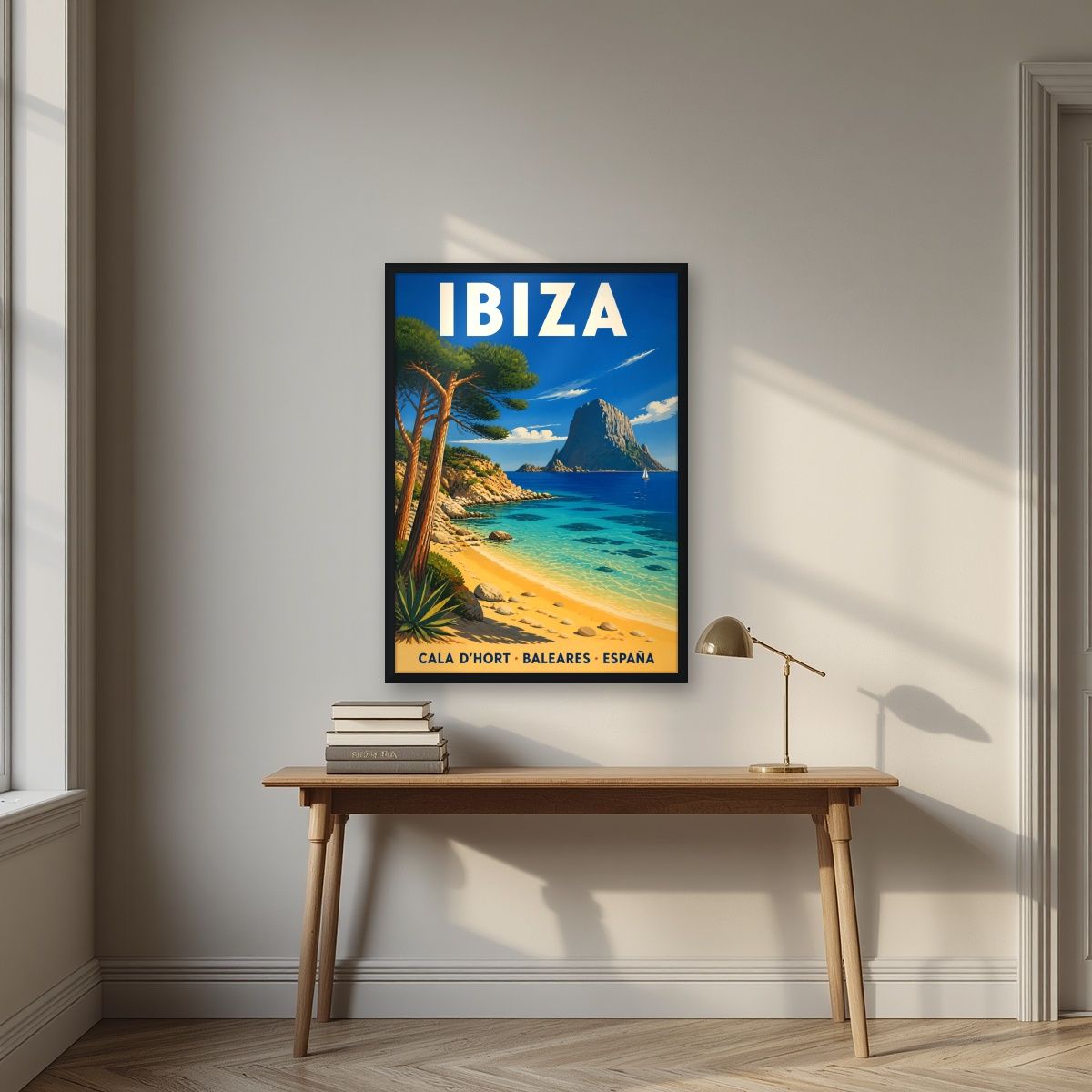Cala d'Hort — Ibiza art print, in a black frame, styled in a desk