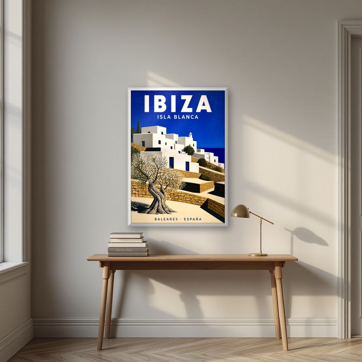 Isla Blanca — Ibiza art print, in a white frame, styled in a desk