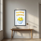 Squeeze The Day – Amalfi Aqua in a black frame, above an oak writing desk