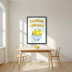 Squeeze The Day – Cabana Green in a black frame, above a dining table in a bright kitchen