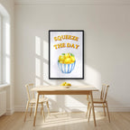 Squeeze The Day – Capri Violet in a black frame, above a dining table in a bright kitchen