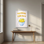 Squeeze The Day – Tuscan Taupe in a white frame, above an oak writing desk