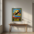 Match Point — Toucan Play That Game art print, in a black frame, styled in a desk