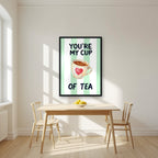You're My Cup of Tea – Cabana Green in a black frame, above a dining table in a bright kitchen