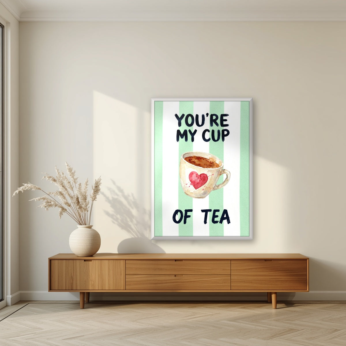 You're My Cup of Tea – Cabana Green in a white frame, above a walnut sideboard in a living room