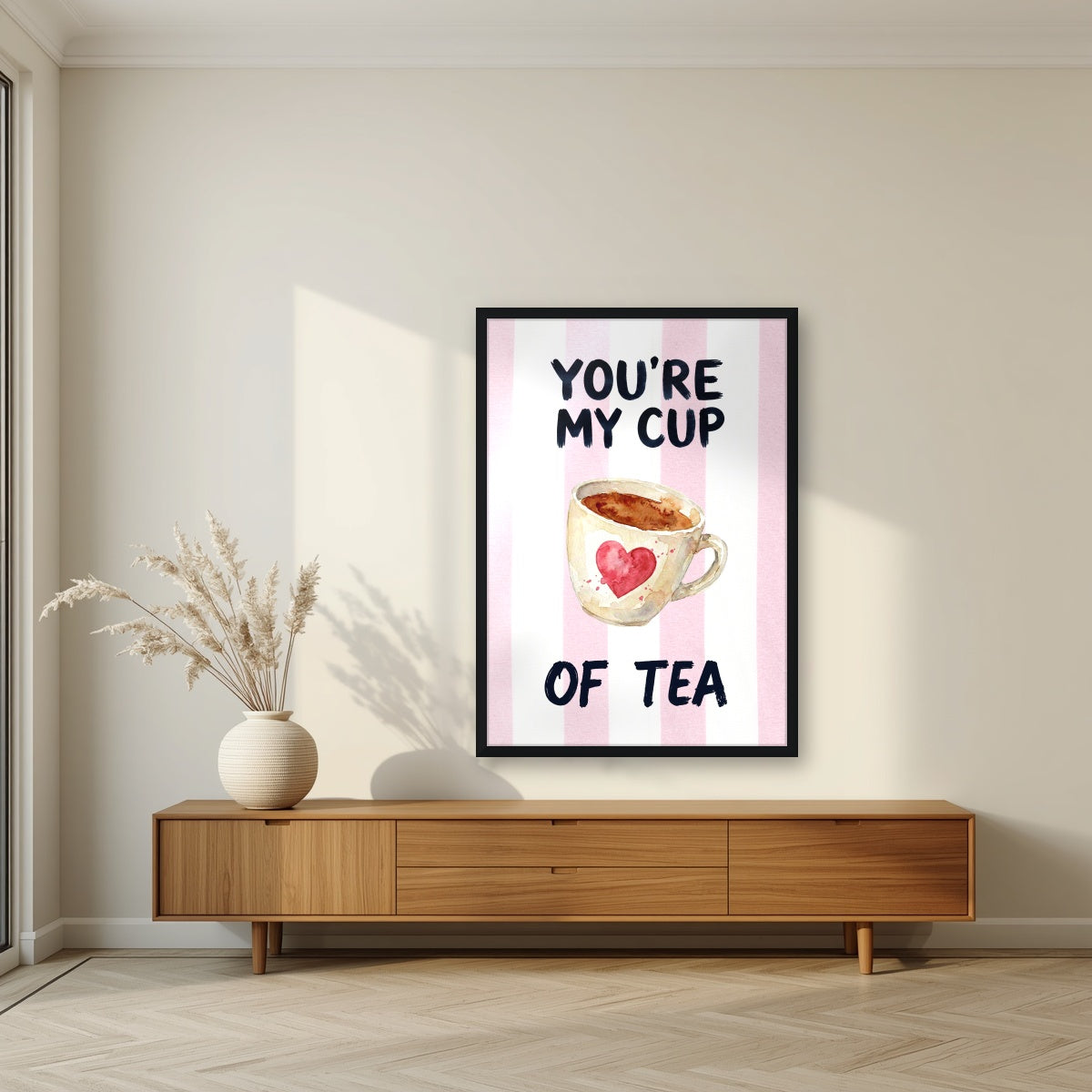 You're My Cup of Tea – Positano Pink in a black frame, above a walnut sideboard in a living room