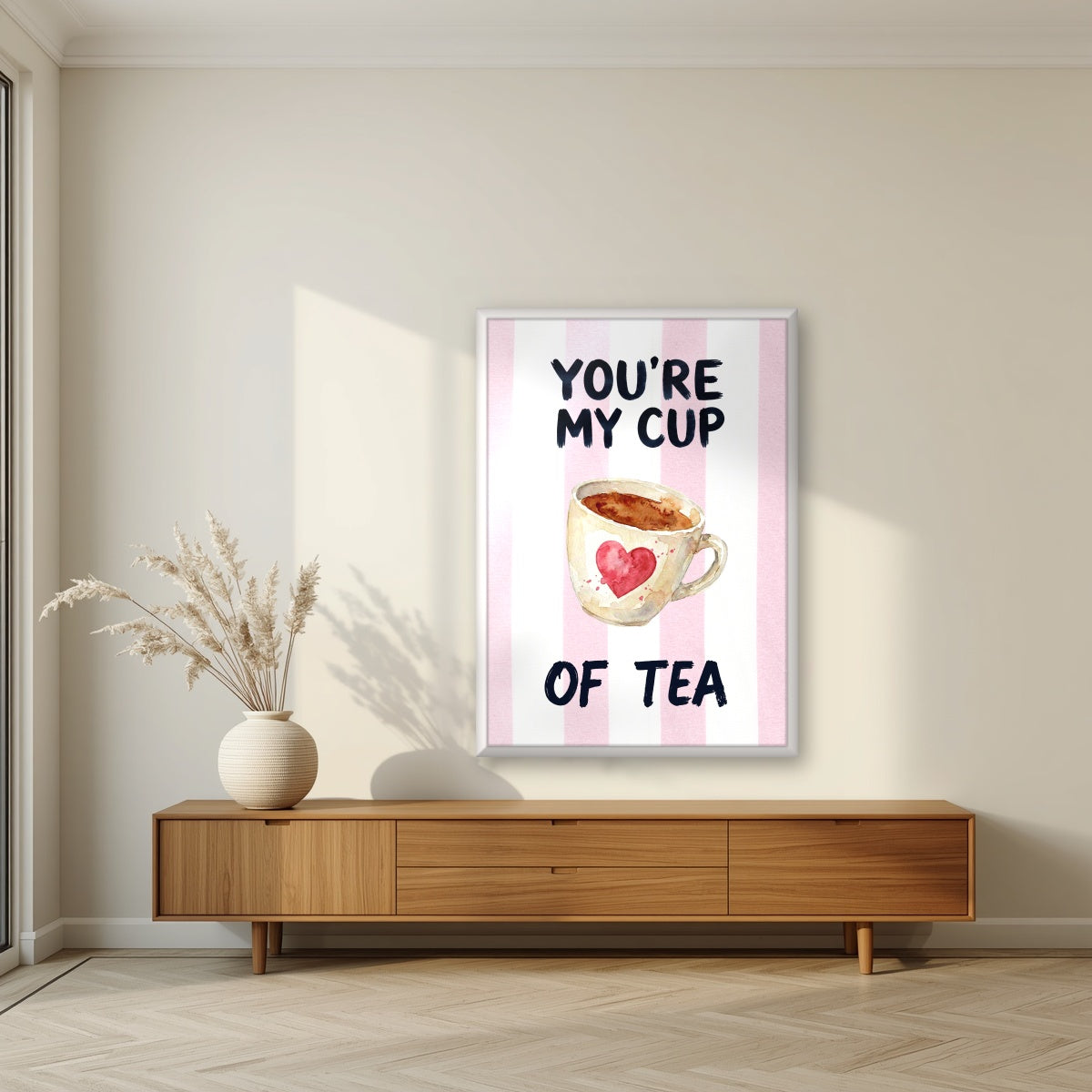 You're My Cup of Tea – Positano Pink in a white frame, above a walnut sideboard in a living room