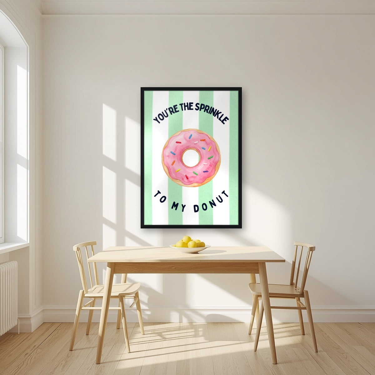 You're the Sprinkle to My Donut – Cabana Green in a black frame, above a dining table in a bright kitchen