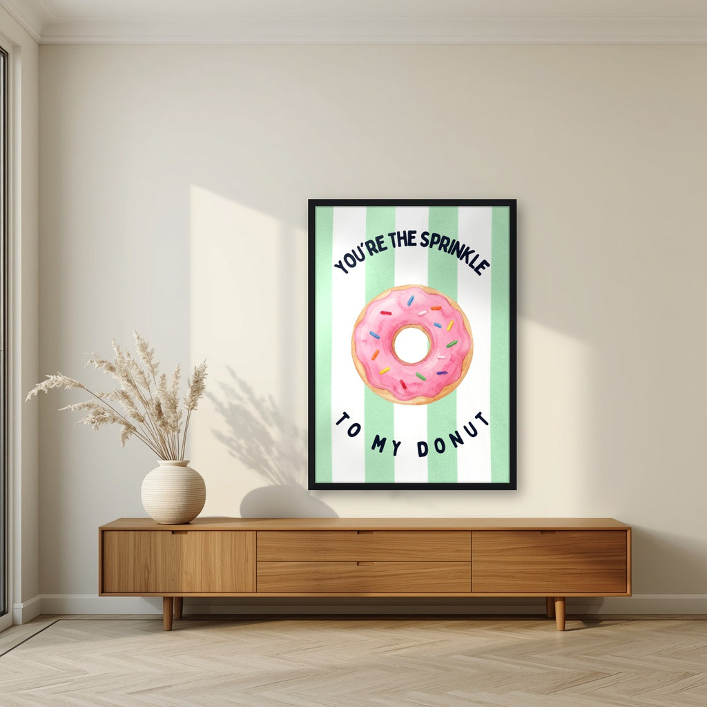 You're the Sprinkle to My Donut – Cabana Green in a black frame, above a walnut sideboard in a living room