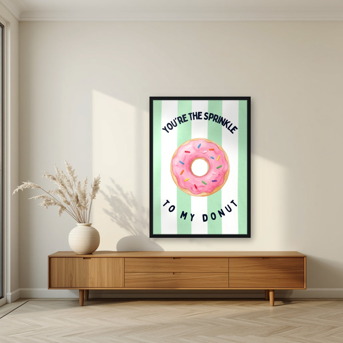 You're the Sprinkle to My Donut – Cabana Green in a black frame, above a walnut sideboard in a living room