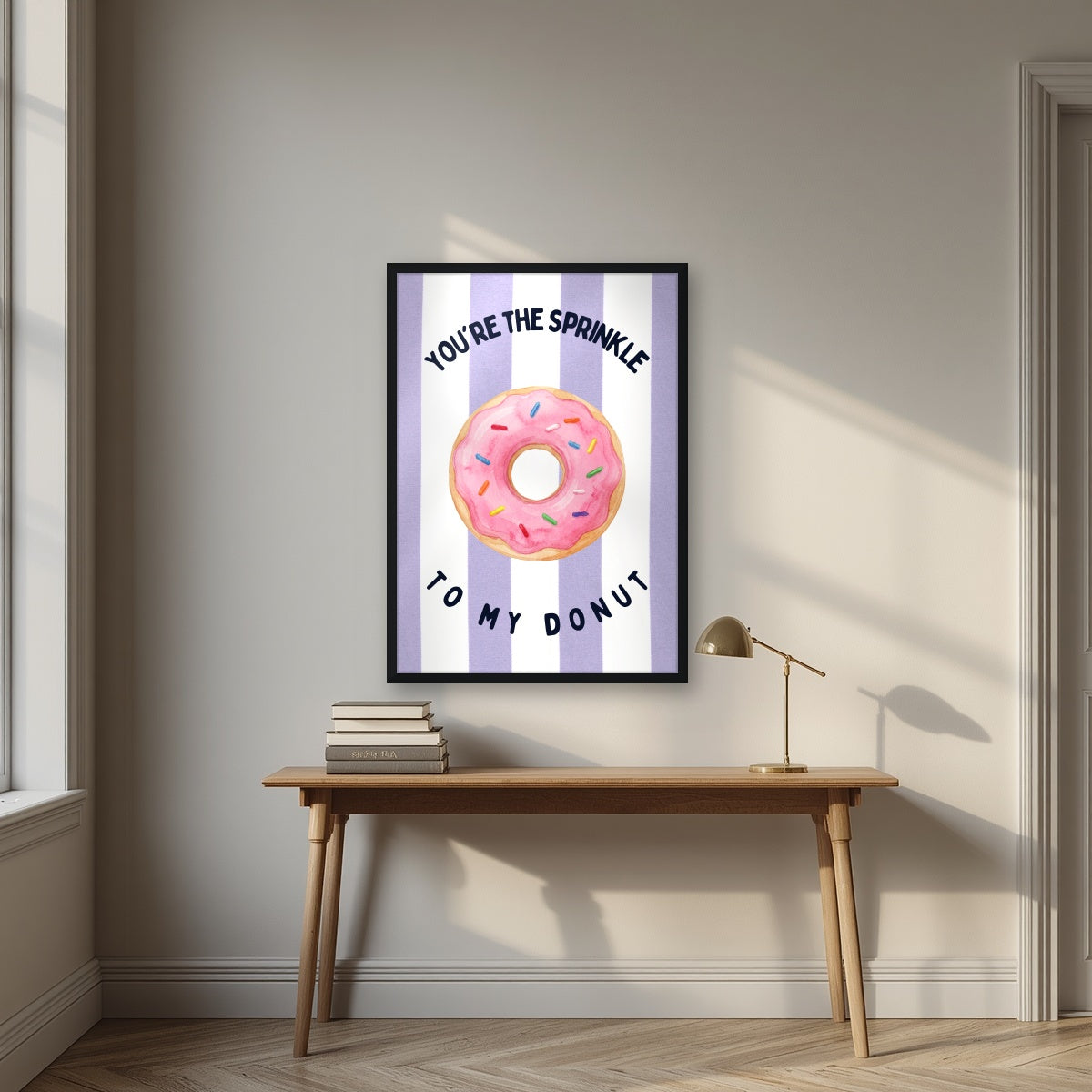 You're the Sprinkle to My Donut – Capri Violet in a black frame, above an oak writing desk