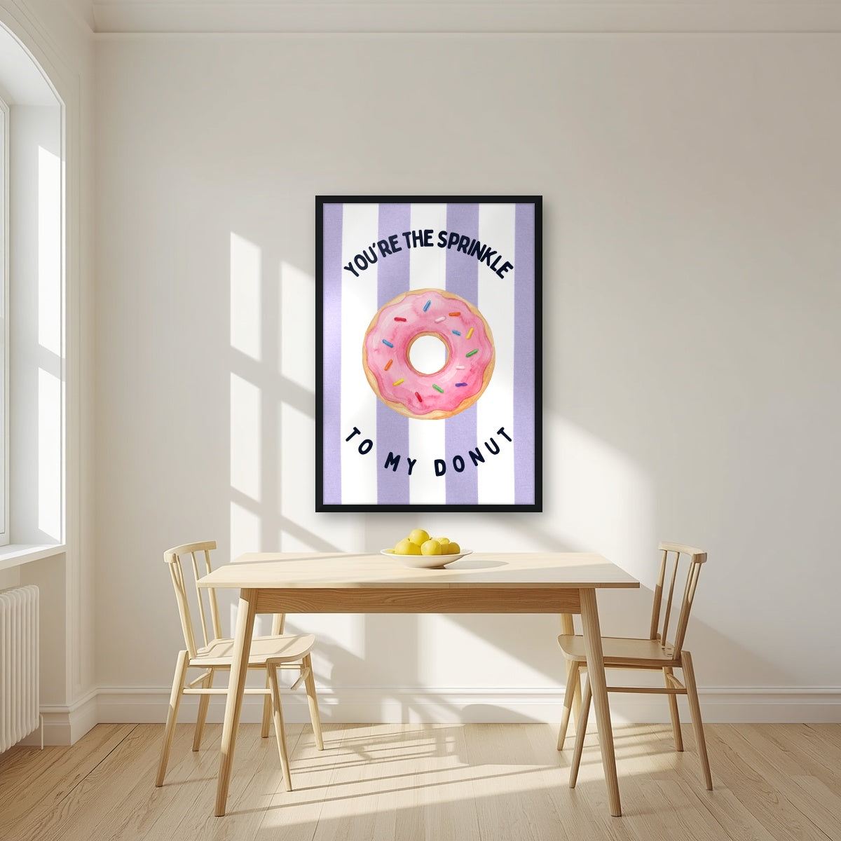 You're the Sprinkle to My Donut – Capri Violet in a black frame, above a dining table in a bright kitchen