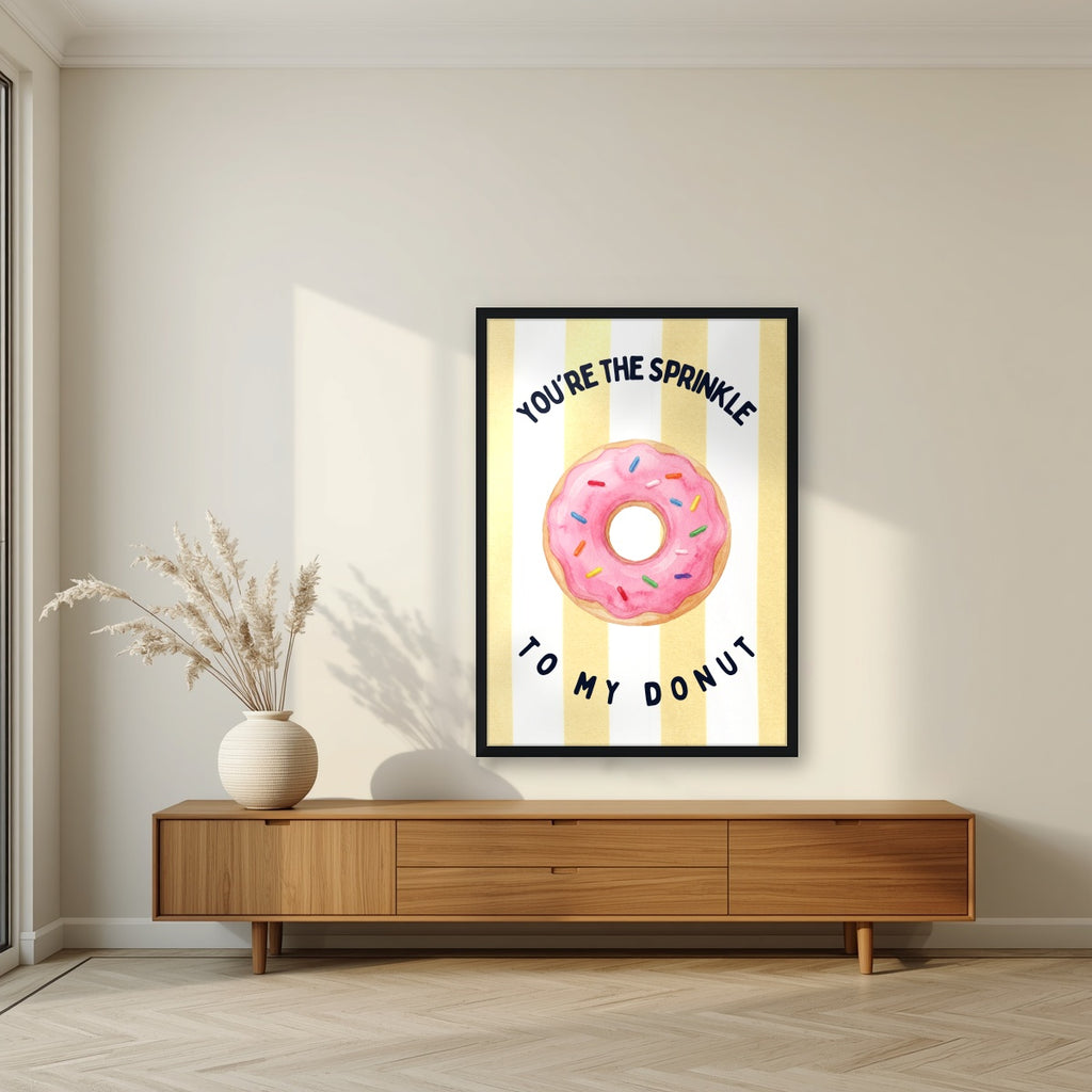 You're the Sprinkle to My Donut – Limoncello in a black frame, above a walnut sideboard in a living room