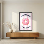You're the Sprinkle to My Donut – Positano Pink in a black frame, above a walnut sideboard in a living room